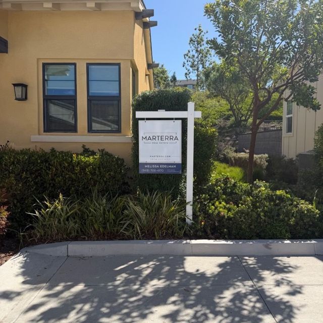 Real estate sign on a R.E.S.S. post in a new luxury Orange County community